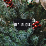 christmas wreath with republique gift card tucked in the center